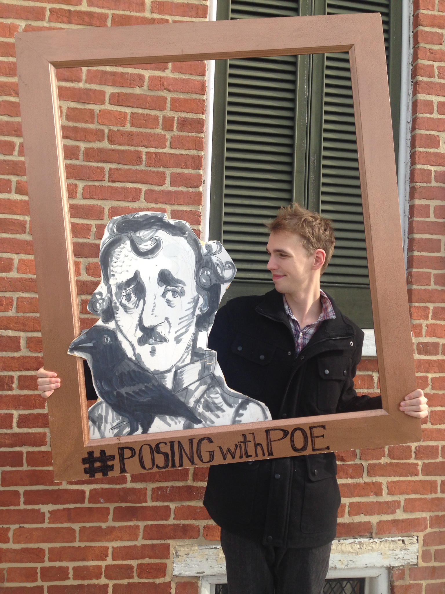 Brady Snuggs posing with Edgar Allen Poe cutout.